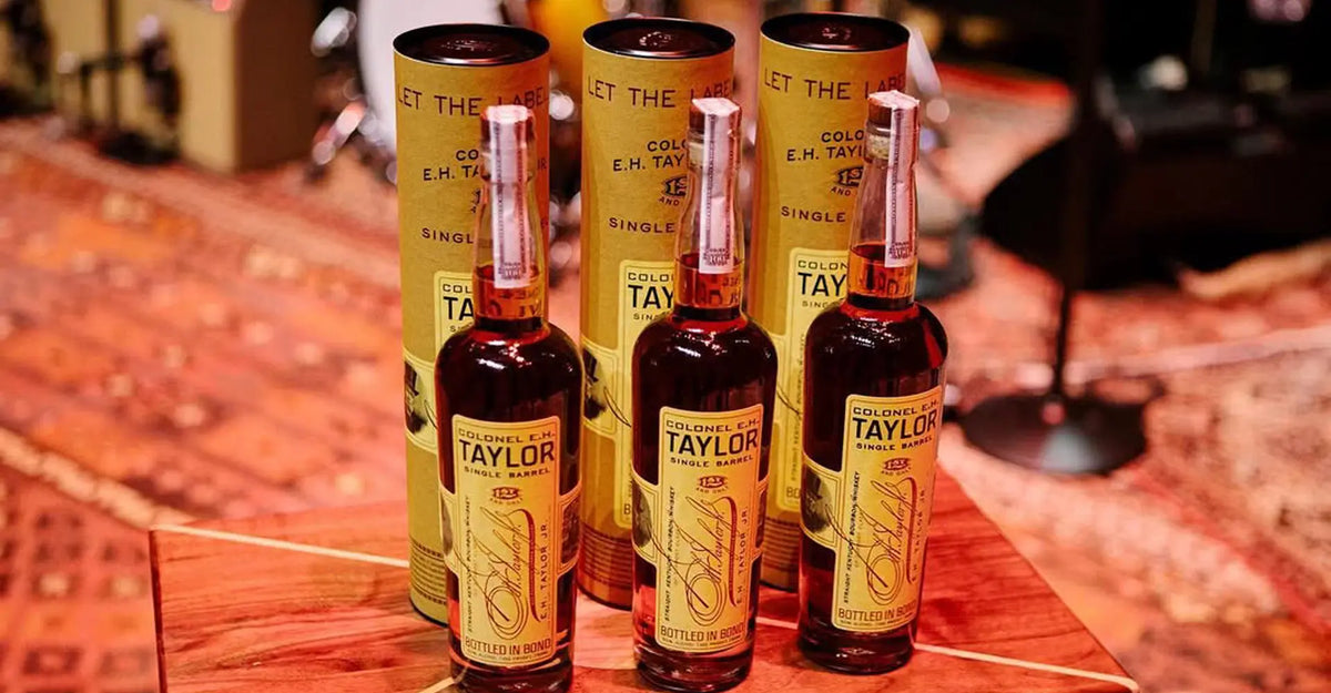 Three bottles of Colonel E.H. Taylor Single Barrel with their canisters
